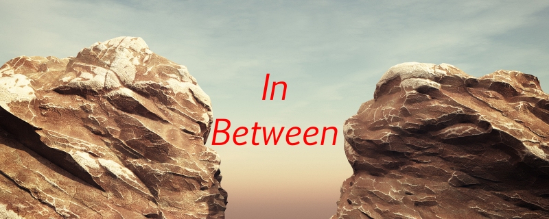 Two large cliffs with the text "In Between" in the air
