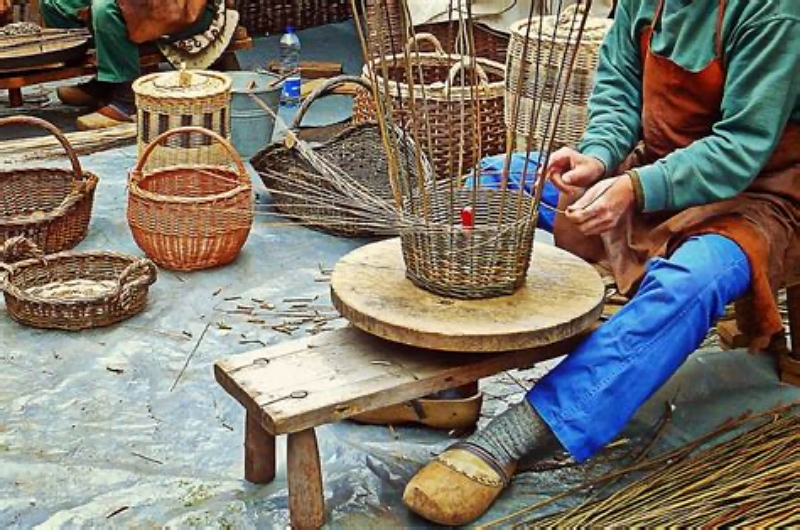 weaver surrounded by baskets